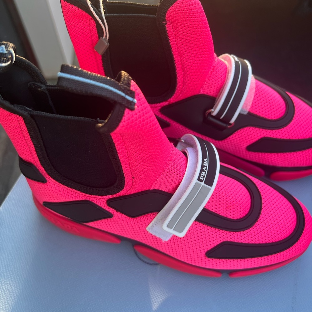 Pink and black Prada sneaker boots.